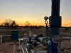 ADZ Energy Carbean-1 plunger lift at sunset